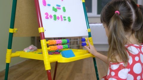 child girl using abacus to learn numbers and account at home