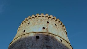 Low angle 4k clip of the White Tower Monument in Thessaloniki, Greece, on a clear morning