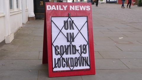 4K: Newspaper Headline Board about The UK being in Coronavirus Covid-19 Lockdown - News stand. Stock Video Clip Footage
