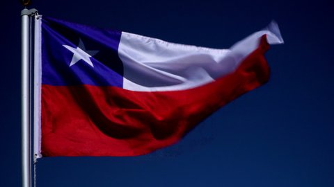 Chile Flag flying in the wind outdoors with Blue sky behind - Chilean flag on flagpole. Stock 4K Video Clip Footage