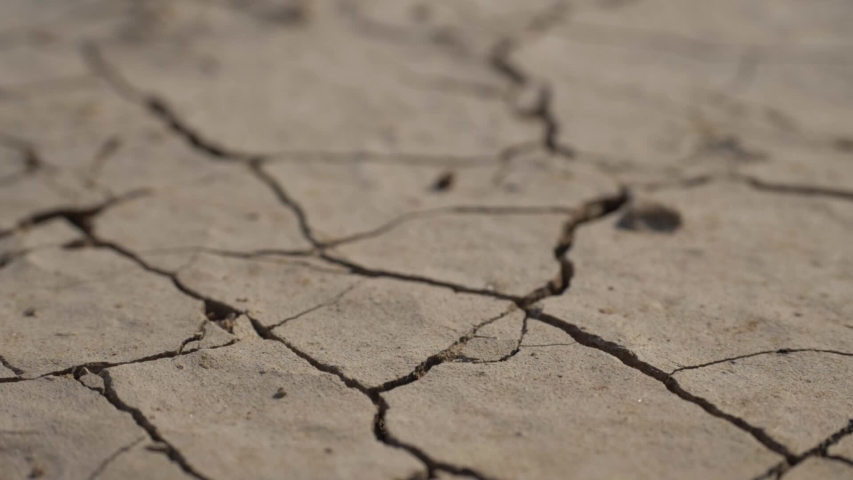 drought concept - lack of water, climate change and global warming. water drop falling. water splash with dry soil on background. ecology concept, nature landscape. water resource use Royalty-Free Stock Footage #1054407101