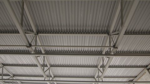 Ceiling of metal construction of a large modern room. Panorama of iron modern ceiling structures of a large restaurant. Modern storehouse construction site, structural steel structure commercial