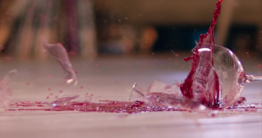 Glass of wine smashing on floor slow motion. Breaking wine glass. Broken wine glass  Royalty-Free Stock Footage #1054410281