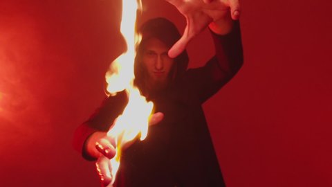 Igniting a fire on the hands of a magician. Close up of the wizard's burning hands pointed at the camera
