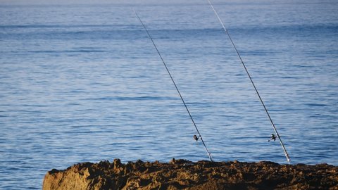 Fishing rod equipment on beach sea shore. Spanish coastline