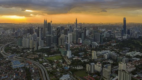 Kuala Lumpur Time Lapse: Sunset of cityscape during a golden sunset overlooking an elevated highway in Kuala Lumpur city. Malaysia. Cinematic.  Prores UHD