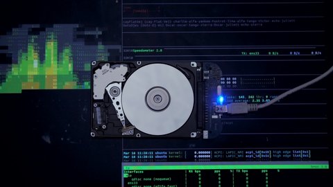 Work of hacked hard drive inside. Hacker breaks sensitive data from a hard drive. Against the background, lines of code and data flash. Cybersecurity. Government secret data hacking technology HDD