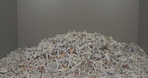 paper from the shredder falls to the bottom