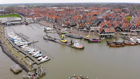 Aerial view of the Tanker Ship entering in the Harbour with the fisherman's wharf in the old city Volendam in Holland at Lake Markermeer.