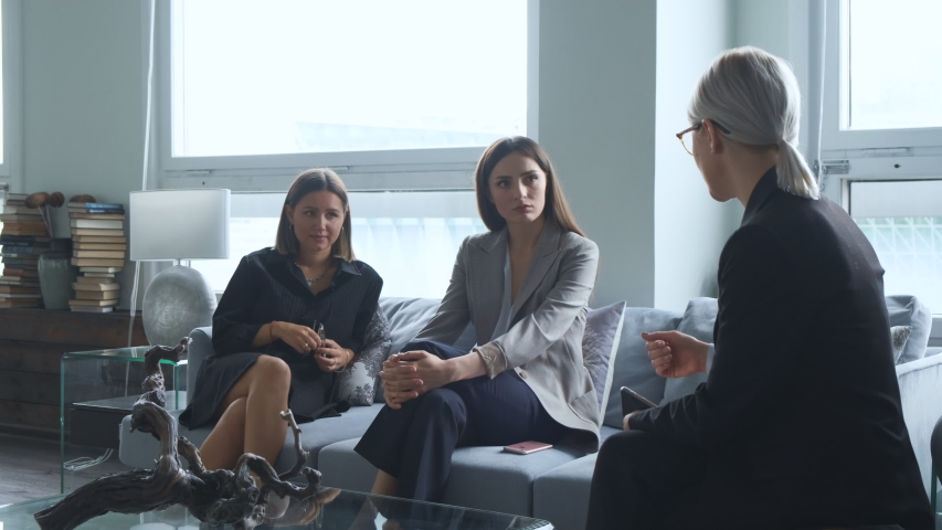 The girls met in the office. Women communicate about the new project and tell stories to each other. Large office.  | Shutterstock HD Video #1054421504