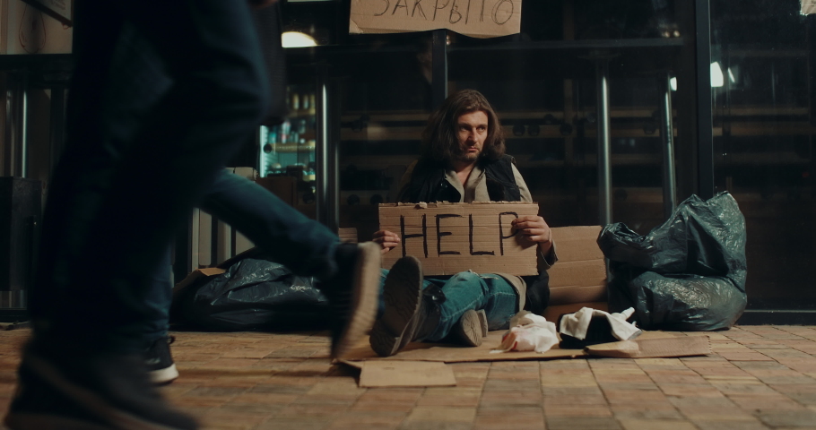 Homeless bum city. Walk crowd people joblessness vagabond help sign poverty 4K. Crowded street Destitute man begging financial crisis jobless. Homelessness poor emigrant tramp. Destitution vagabonds. | Shutterstock HD Video #1054424687