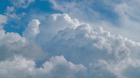 Blue sky white clouds. Puffy fluffy white clouds. Cumulus cloud scape timelapse. Summer blue sky time lapse. Dramatic majestic amazing blue sky. Soft white clouds form. Cloud time lapse background 4K.
