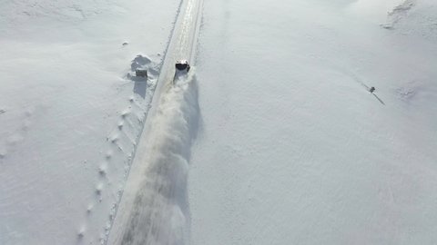Snow removal on the roads in Norway. Aerial photography. Panoramic view. Roads in winter Norway. Car for cleaning snow. Snowplows in Norway