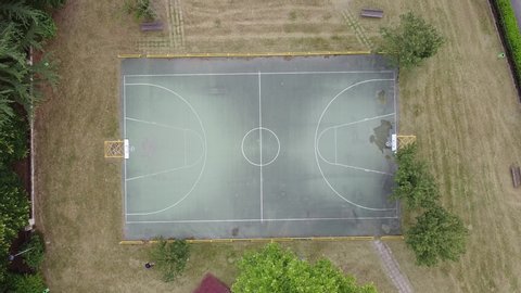 Basketball playground perpendicular drone view and zoom in on the center of the court