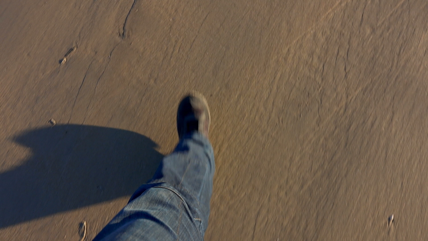 Man is joggong along the wet sand beach. View from above on the legs  | Shutterstock HD Video #1054427054