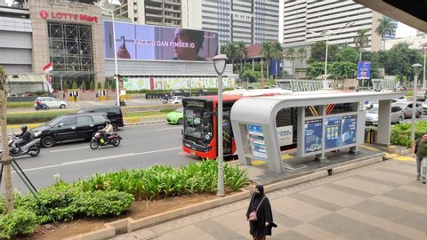 Jakarta, Indonesia - Dec 21, 2019 Transjakarta Bus Stop, Gelora Bung Karno, City Bus Metrotrans In front of Lotte Mart Ratu Plaza, Indonesia