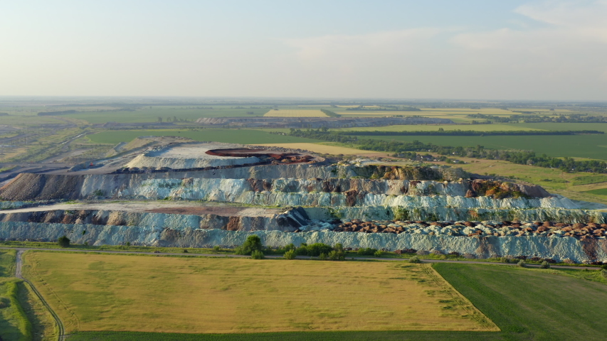 Aerial view of a large mound from different rocks near an open pit. Mining and processing plant