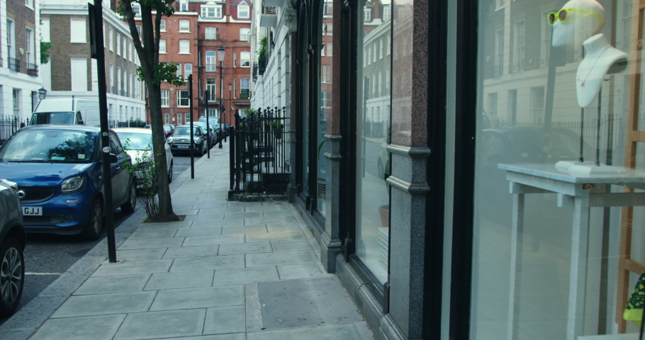 Mixed race homosexual couple window shopping in London, England.