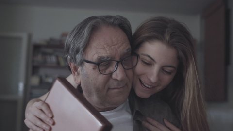 Young daughter embracing her father with love and giving present