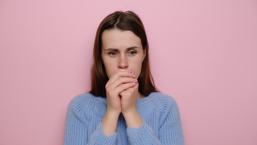 Worried brunette woman feeling nervous, thinking of breaking up or divorce, wears sweater, isolated on pink background. Anxious doubtful girl, suffering from depression, worrying about wrong decision Royalty-Free Stock Footage #1054442780