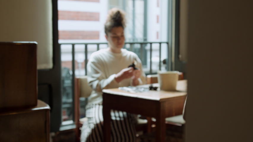 MS DEFOCUSE Woman cleaning cutlery with napkin, Hull, United Kingdom