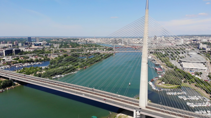 Aerial view of Ada bridge, a cable-stayed bridge over the Sava river and a major traffic route in Belgrade, Serbia Royalty-Free Stock Footage #1054449305