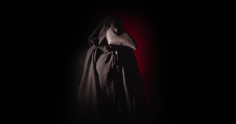 A black plague doctor entering a room in the dark