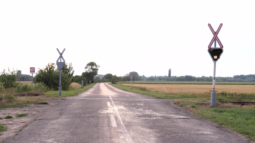 Rural railway crossing, rural car road in europe