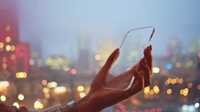Handheld shot of girl using mock-up transparent cellphone for animation. Young woman typing message on blank futuristic smartphone entertaining virtual reality. - Powered by Shutterstock - Get 15% off with code: PIKWIZARD15