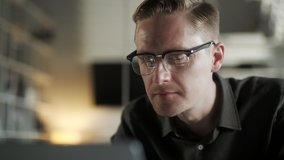 Professional Creative Man Sitting At His Desk In Home Office Studio Working Typing On a Laptop. Young Male Professional Using Computer Sitting At Office Desk. Busy Worker Freelancer Working On - Powered by Shutterstock - Get 15% off with code: PIKWIZARD15