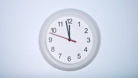 Slow motion time at 11.58 o'clock, Wall clock isolated on white background, Clock minute walk slowly, Time concept.
