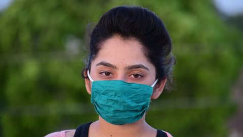 Virus mask Indian woman on street wearing face protection in prevention for coronavirus covid 19. shot in 4k resolution.