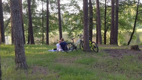 couple of lovers resting in a pine park