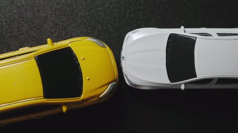 Car crash scene. Two toy cars smashed. Auto accident. Top view.