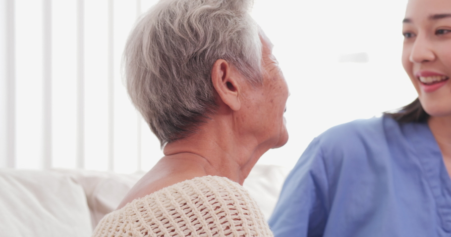 Attractive woman holding with her grandmother at home. They holding together with happy emotion. Close up happy woman face.