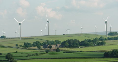A wind farm on a beautiful summers day, set in the green hills of Yorkshire. This clip contains two shots with different compositions.