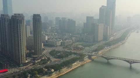 flight over changsha city downtown famous riverside traffic bay bridge sunny day aerial panorama 4k china