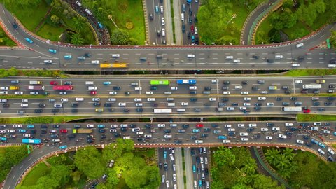 jakarta city center sunny day busy traffic street road junction aerial topdown panorama 4k indonesia
