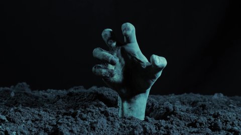 Zombie hand rising out from the grave