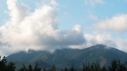 Ski mountain in the summer with passing cloud cover time lapse