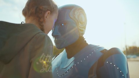 At sunlight child girl greets her robot friend touching each other foreheads future machine intelligence artificial humanoid science robotics digital virtual fiction communication close up slow motion