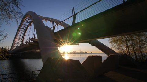 View of Toronto skyline through supports of Mimico bridge at sunrise. Beautiful spring morning in Toronto.