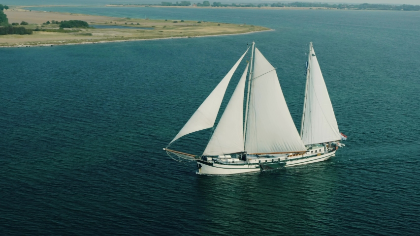 White ship sailling near coastline