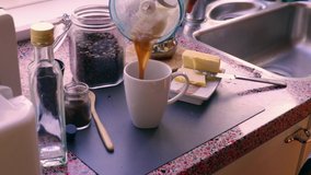 Person making keto coffee with butter and MCT oil at home