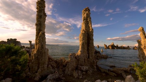 Cinematic tracking shot of sunset sky over tufa formations at Mono Lake, California 