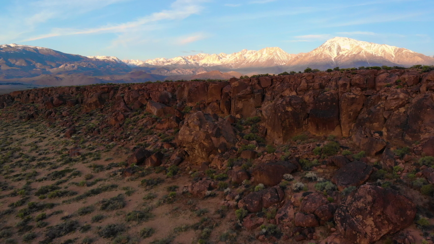 Cinematic aerial shot of sunrise sky over Volcanic Tableland in Eastern Sierra, California