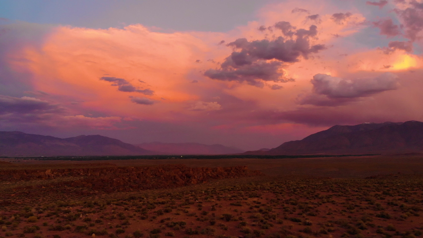 Cinematic aerial shot of sunset sky over Volcanic Tableland in Eastern Sierra, California