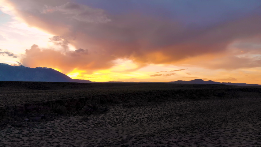 Cinematic aerial shot of sunset sky over Volcanic Tableland in Eastern Sierra, California