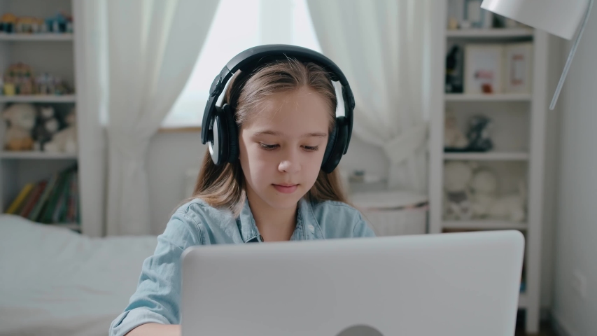 Beautiful girl student in headphone study online with internet teacher learn looking at laptop, distance education concept slow motion Royalty-Free Stock Footage #1054523927