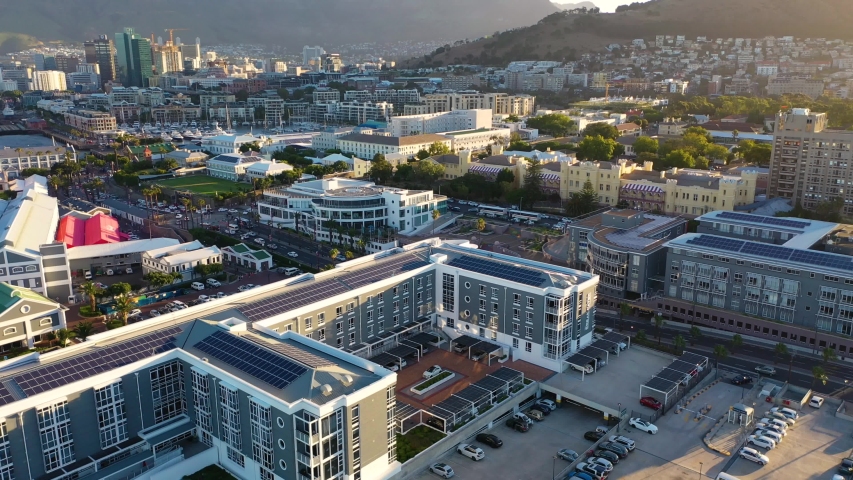 Establishing aerial view of downtown cape town with table mountain and lion head in the background.